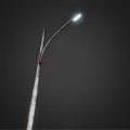 Outdoor Street Light with Curved Arm and Metal Pole Lit Up Bright White at Night