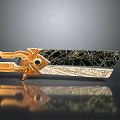 Ornate Golden Metal Decor With Black Cracked Surface Green Gem And Reflection Base
