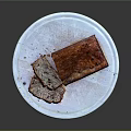 Freshly Baked Banana Bread with Slices on White Ceramic Plate