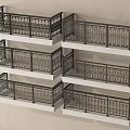 Black Metal Balcony Railings With Intricate Patterns On Multiple Levels Light Beige Wall Background
