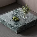 Green Marble Coffee Table with Green Fruits Black Bowl and Glass Vase Holding Green Plants