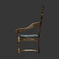 Vintage Wooden Chair With Ornate Carvings And Blue Fabric Cushioned Seat
