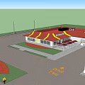 Commercial Complex Featuring McDonald's Restaurant With Red Roof Yellow Signage White Fence And Red Umbrellas