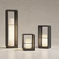 Three Black Framed Outdoor Lights With White Candle Shaped Light And Modern Design
