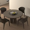 Modern Round Dining Table Set with Four Dark Chairs and Fruit Tray in Indoor Area