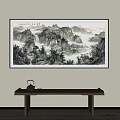 Traditional Chinese Landscape Painting with Mountains Water Trees Mist Hanging on Wall Above Wooden Table