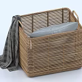 Natural Woven Rattan Storage Basket With Handle Holding Gray Cushion And Plaid Blanket