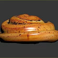 Freshly Baked Cinnamon Roll With Spiral Shape Golden Brown And Cinnamon Swirls On Black Surface