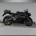 Black Sporty Motorcycle With Racing Design On Platform Against Gray Background