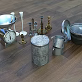 Vintage Metal Household Items Including Scale Candle Holders And Canisters On Wooden Floor