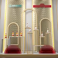 Luxurious Retail Window Display With Golden Arched Design Red Accents And Decorative Items