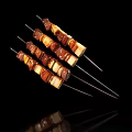 Colorful Grilled Meat And Vegetable Skewers On Black Background With Charred Edges