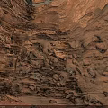 Natural Red Rock Interior With Sunlit Holes And Textured Stone Walls