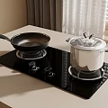 Black Glass Stove Top With Frying Pan And White Pot On Kitchen Countertop