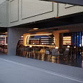 Modern Style Bar With Awning Warm Lighting Wine Racks Bar Counter And Tables From Outside