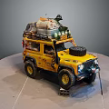 Yellow Off Road Vehicle Model With Roof Luggage Spare Tire And Adventure Gear