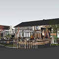 Traditional Guesthouse Building With Tiled Roof Outdoor Seating Sun Umbrellas Green Plants And Gravel Path