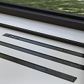 Black Long Strips Placed On White Surface By Window With Green Grass View 3d model