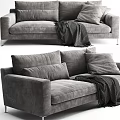 Gray Velvet Two Seater Sofa Upholstered with Soft Pillows and Cozy Knit Blanket