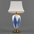 Elegant Table Lamp With White Lampshade And Blue White Diamond Pattern Base Golden Accents