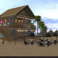 Beachfront Wooden Cabin With Thatched Umbrellas Outdoor Seating And String Lights On Sandy Beach