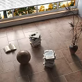 Sunlit Room With Stacked Books Magazines Open Book Football Vase On Tile Floor
