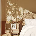 Wooden Nightstand Beside Bed With Vintage Lamp Flower Vase And Photo In Sunlight Shadows