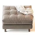 Cozy Taupe Ottoman With Tufted Cushion Soft Blanket And Wooden Legs
