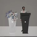 Black Podium with Huawei Logo and Man Standing Near White Vase with Blue Pink Flowers