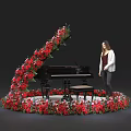 Floral Installation Surrounding Black Piano With Red And Pink Flowers And Woman Standing By