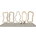 Various Shaped Wooden Mirrors Wall Mounted in Modern Interior With Patterned Floor and Decorative Cat