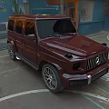 Red Mercedes Benz G Class SUV Parked In Parking Lot Next To Blue Building With Graffiti
