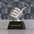 Three Golden Silver and Crystal Trophies with Black Bases and Engraved Team Recognition Text