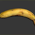 Ripe Yellow Banana with Brown Spots on Gray Background and Reflection