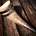 Natural Ox Horn Drinking Cup With Black Leather Straps On Wooden Floor
