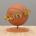 Decorative Ornament Set with Orange Basketball and Stand Golden Curry is Text on Wooden Tabletop