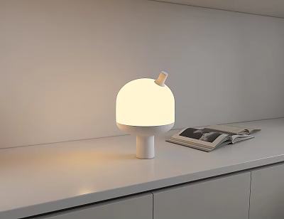 Minimalist White Lit Table Lamp With Round Shade On White Countertop And Open Magazine 3d model