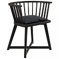 Modern Black Dining Chair With Slatted Backrest Gray Cushion And Crossed Legs