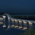 Elegant Modern Arch Bridge Illuminated At Night With Scenic Reflections On Calm Water Surface