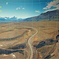 Scenic Wilderness View With Winding Road Distant Mountains Blue Sky White Clouds And Meandering River