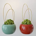 Two Green And Red Ceramic Potted Plants With Golden Metal Rings And Fresh Green Foliage
