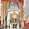 Ornate Classic Fireplace With Marble Columns Draperies Statues And Armchair In Elegant Room