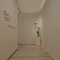 Clean Bright Beauty Salon Interior With White Sofas Beauty Product Shelves And Tall Lamp