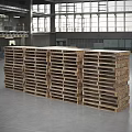 Industrial Equipment Wooden Pallets Neatly Stacked In Spacious Industrial Interior With Tall Windows Metal Structures