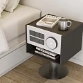 Modern Black White Bedside Table With Silver Mug Notebook Radio Books on Metal Stand