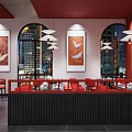 Modern Restaurant Interior With Red Walls Red Chairs Open Counter And Food Displays