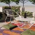 Cozy Outdoor Patio With White Metal Rocker Chair Table Green Plants Colorful Rug And Cushions