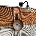 Wall Lamp With Black Arm Transparent Glass Shade On Brown White Concentric Circle Decorative Panel
