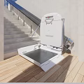 Outdoor Wheelchair Lift Attached to Staircase With Wooden Deck and White Metal Frame