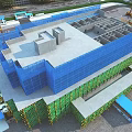 Aerial Planning of Construction Site With Under Construction Building Crane Scaffolding and Green Safety Netting